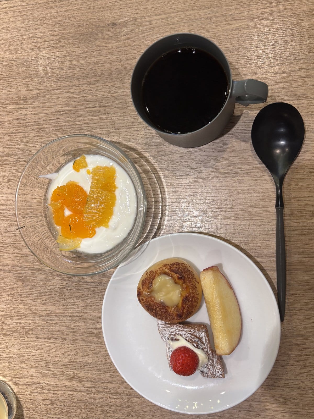 フルーツを乗せたヨーグルトとチーズパンとコーヒーを合わせたOMO7旭川の締めの朝食